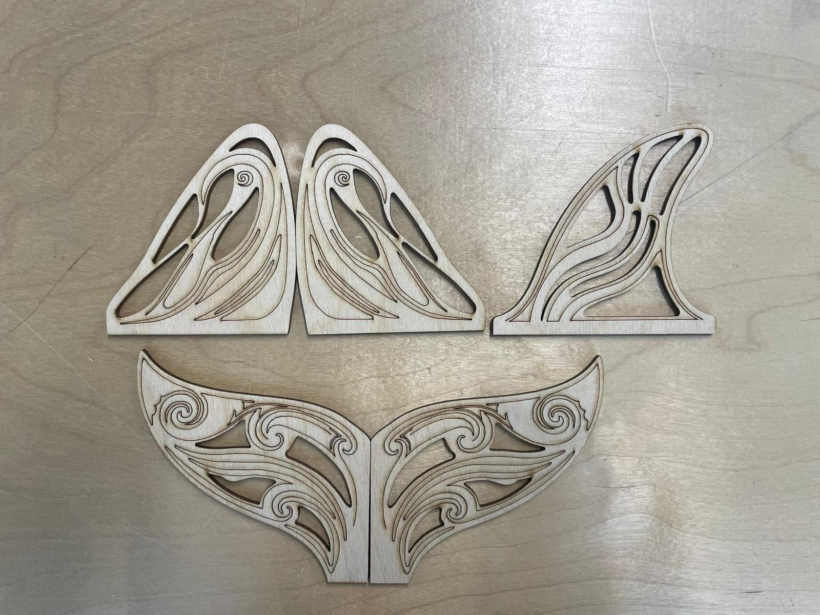 Finished laser-cut plywood fin and tail panels for the Orcar on the workbench