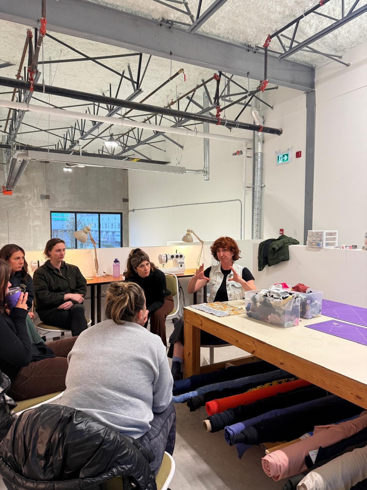 A Friday-night workshop at Create Makerspace — community members gathered around the fabric studio